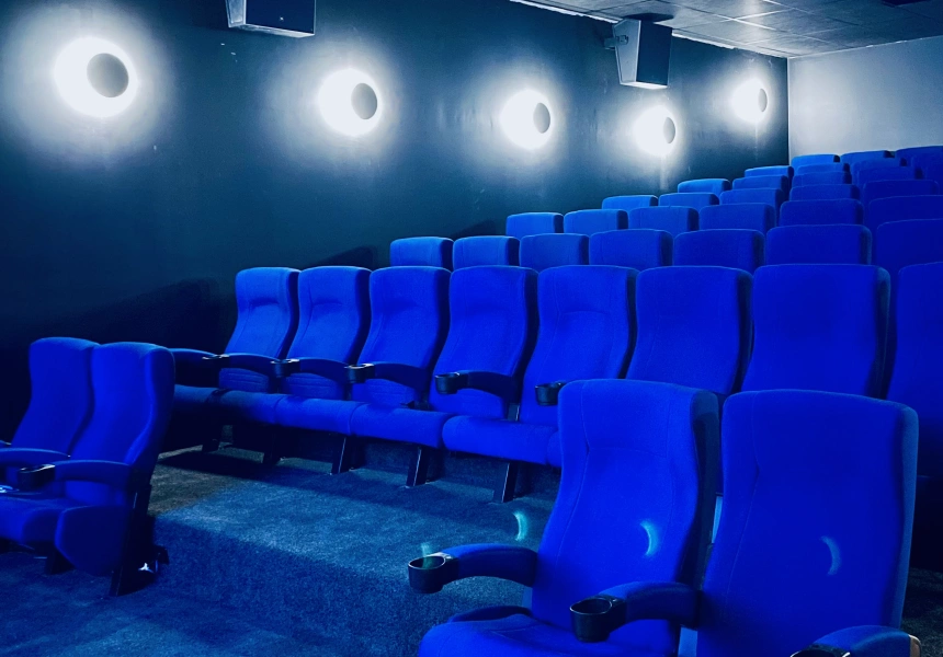 Eclipse Cinema in Collingwood — deep blue velvet seating lit by circular wall sconces.